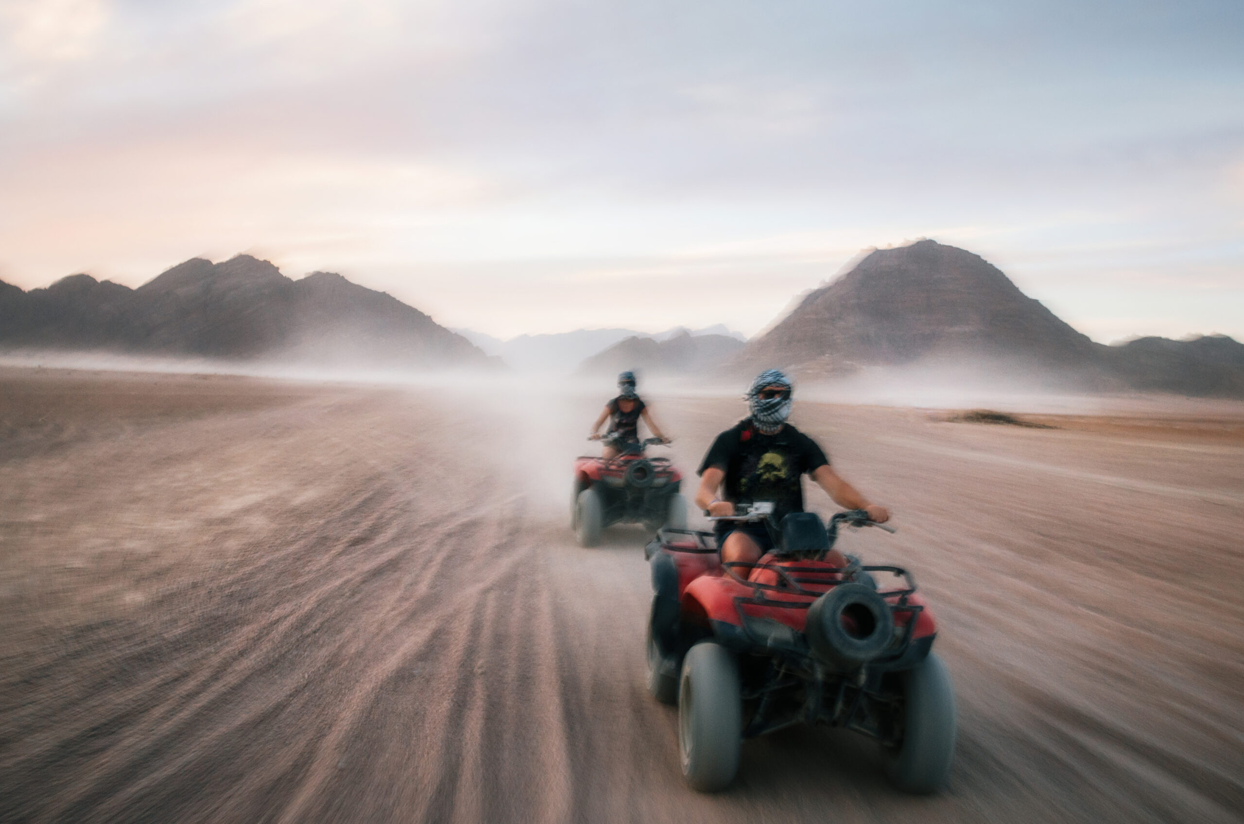 "Private quad bike tour in the Hurghada desert during sunrise or sunset with golden dunes scenery"